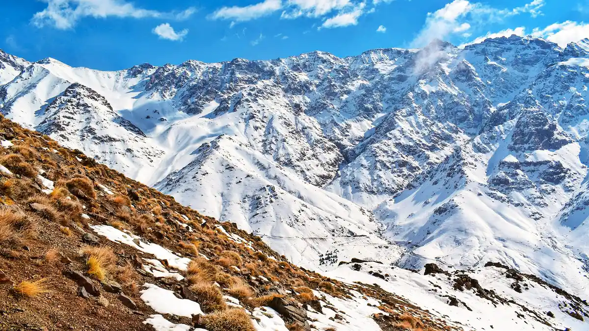 snow on the atlas mountains with blue sky in morocco