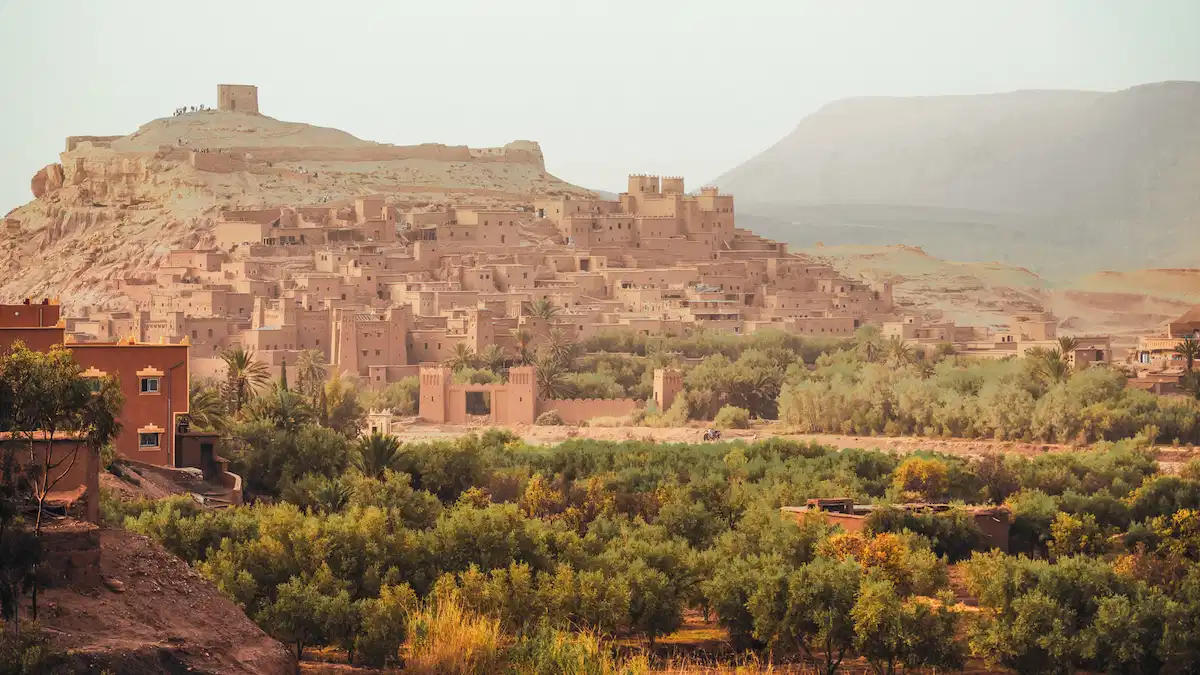 kasbah ait benhaddou with the green oasis surrounding it in morocco