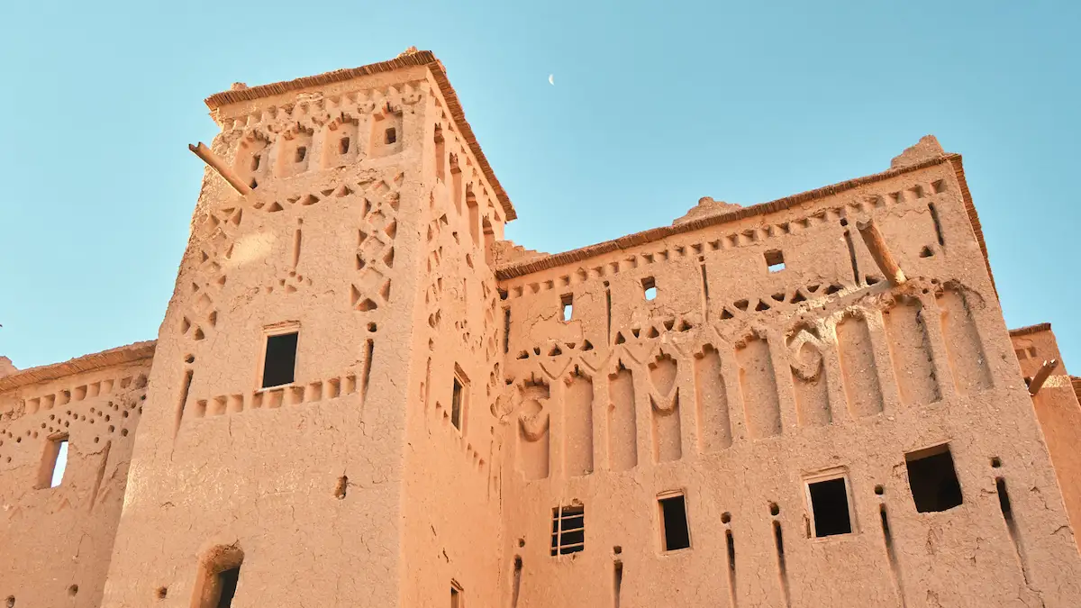 kasbah ruins with blue sky and the moon