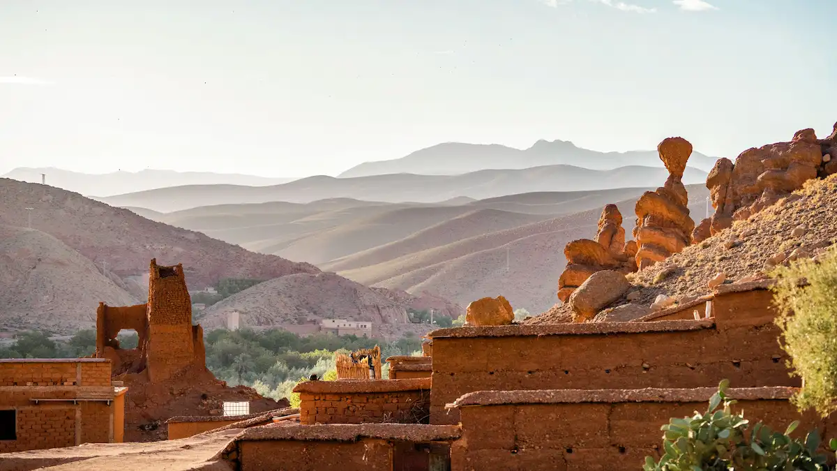 landscape of old kasbah ruins and a range of atlas mountains in morocco