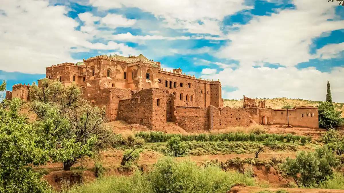 talouet kasbah ruins and green trees in morocco