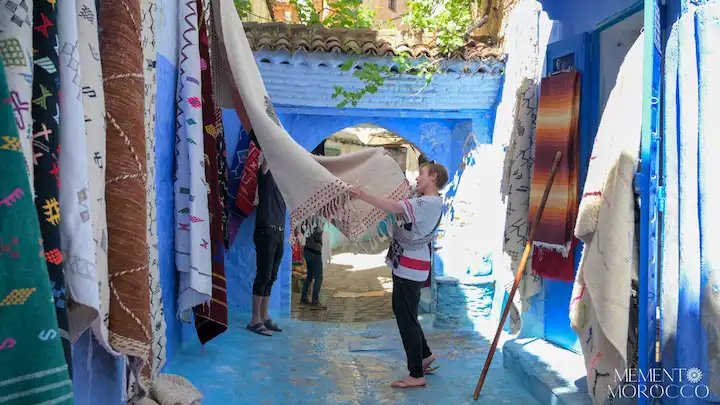 women shopping carpet at chefchaouen city