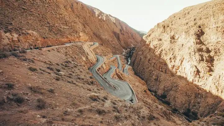 serpentine road and river of dades valley in morocco