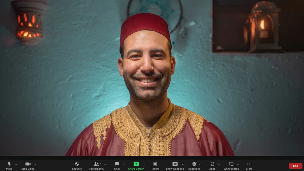 moroccan man with moroccan dress in a zoom meeting with customers