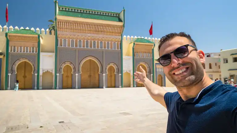 handsome man in front of fes royal palace