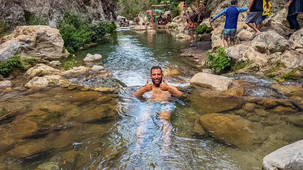 a man swiming in akchour waterfalls