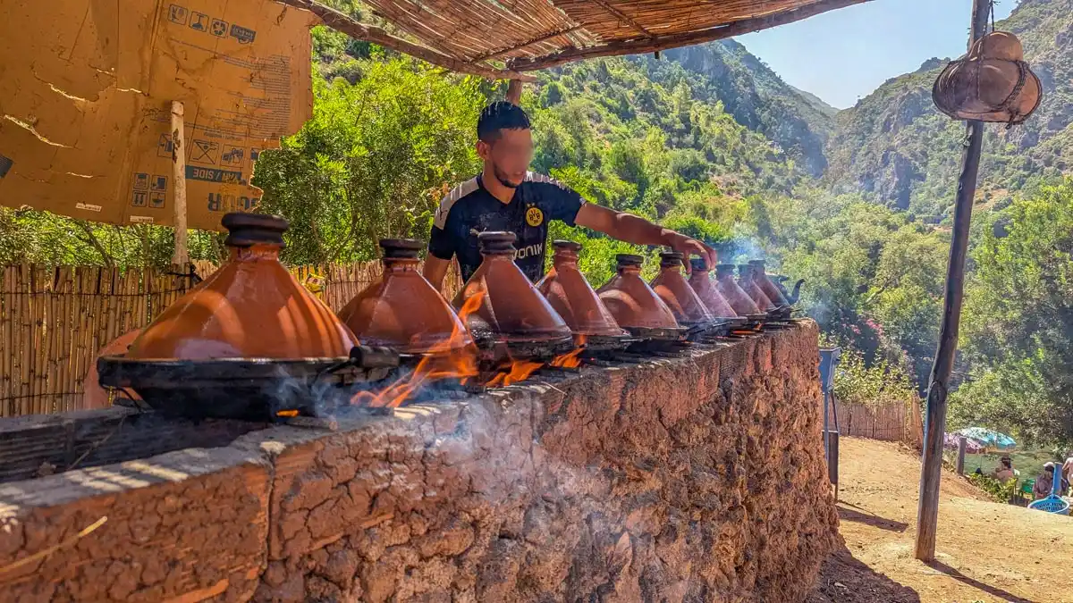 a man cooking food in a restaurant in Akchour