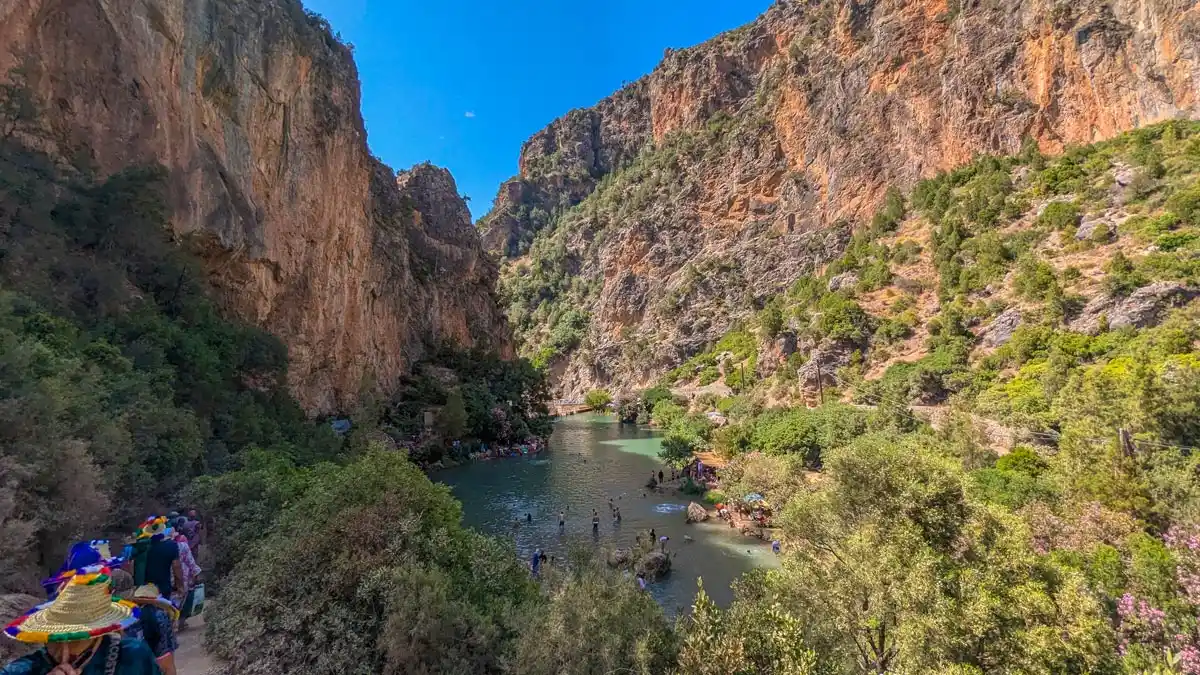 mountain and water in between in akchour waterfall