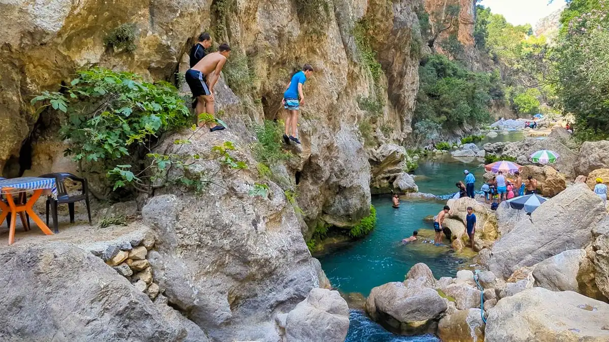 guy jumping in akchour waterfalls