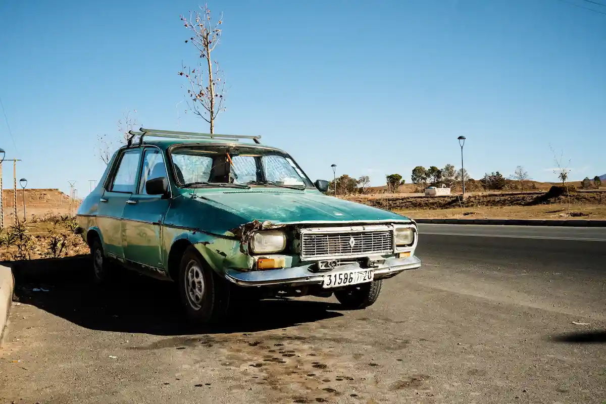 a green car parked on a road in morocco