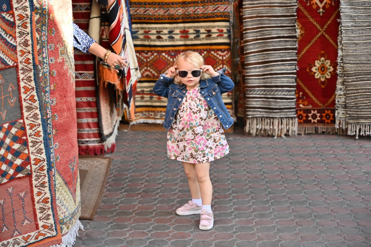 Child shopping for carpets in the Habous of Casablanca